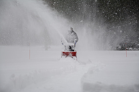 man holding red snow blower thumbnail