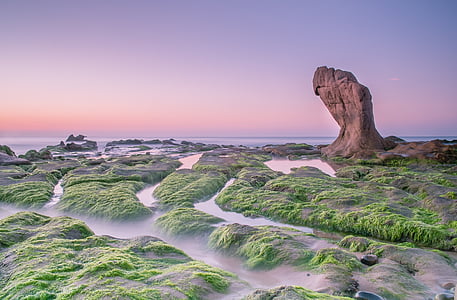 large rock formation and green trees at the bottom thumbnail