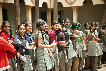 group of woman form in line while holding paper plate thumbnail