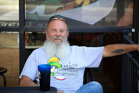 man sitting beside the fence thumbnail