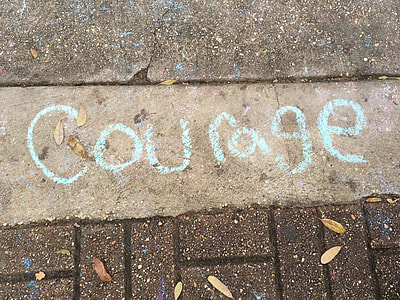 teal courage text on brown pavement thumbnail