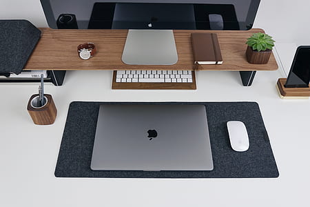 MacBook with Magic Mouse near keyboard and black mat thumbnail
