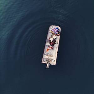 person on white boat thumbnail