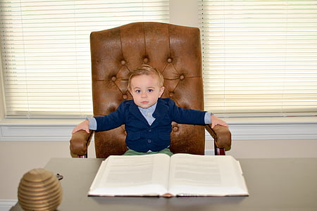 boy sitting on office chain in front of book thumbnail