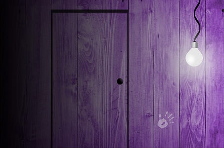 light bulb near purple wooden wall with door thumbnail