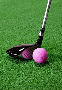 black and gray golf club near pink golf ball on field during daytime thumbnail