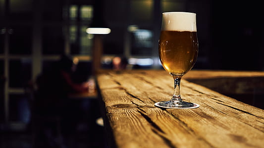 clear beer pilsner on brown table thumbnail