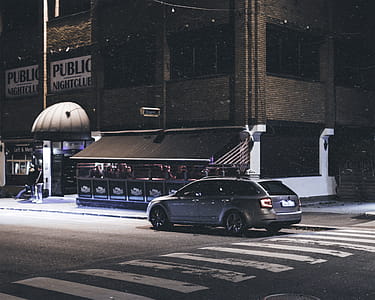 Gray Station Wagon Parked on Road at Night thumbnail