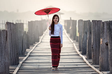 woman holding red umbrella thumbnail