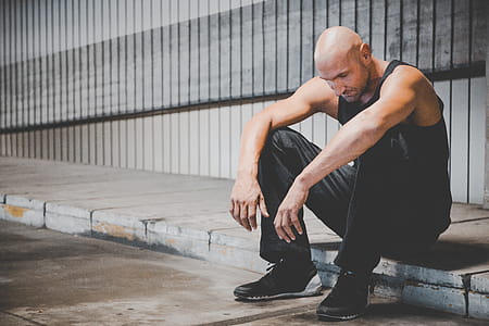 Man Sitting on Sidewalk thumbnail