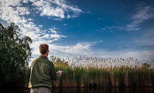 man fishing near body of water thumbnail
