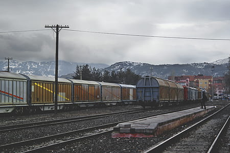Train Running on Train Track Under Gray Sky at Daytime thumbnail
