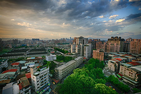 aerial photography of high rise buildings under cloudy sky thumbnail