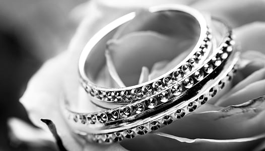 grayscale photography of silver-colored bracelets thumbnail