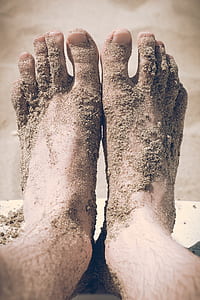 human feet covered with sand thumbnail
