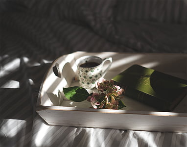 cup on white wooden tray near soap thumbnail