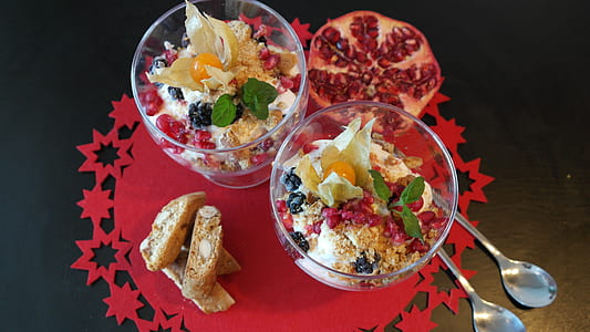 two dessert in bowls beside spoons thumbnail