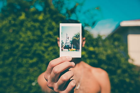 man holding photo thumbnail
