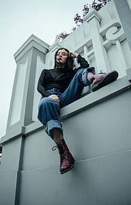 woman sitting on white wall thumbnail