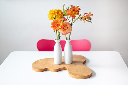 orange flowers on white ceramic vases thumbnail