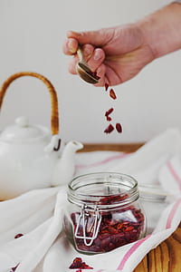 person pouring nuts in jar thumbnail