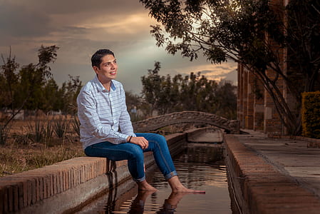 smiling man wearing blue striped dress shirt thumbnail