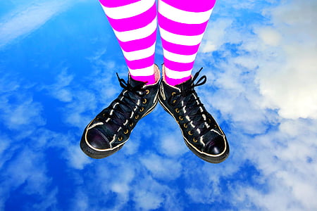 person wearing pair of black low-top sneakers thumbnail