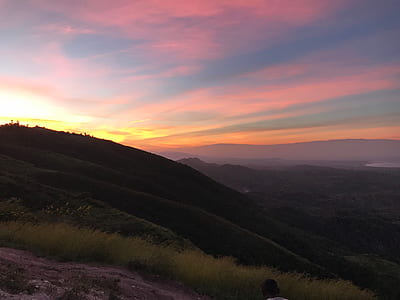 grass covered hills during sunset thumbnail