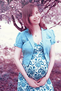smiling woman wearing blue floral dress thumbnail