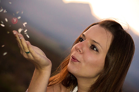 shallow focus photography of woman blowing thumbnail