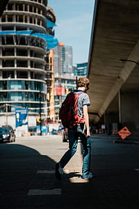 man walking on concrete pathway thumbnail