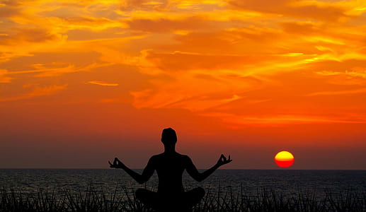 silhouette photography of person meditating facing sun set thumbnail
