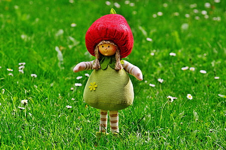 red and green plush toy on green grass field thumbnail