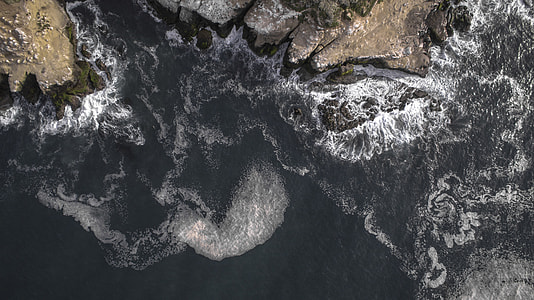 aerial view of cliff and body of water thumbnail