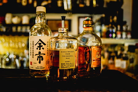 Three Assorted Liquor Bottles on Table thumbnail