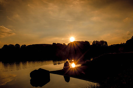 silhouette photography of person near lake thumbnail