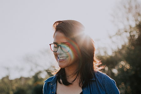 woman in front of green leafed tree during daytime thumbnail