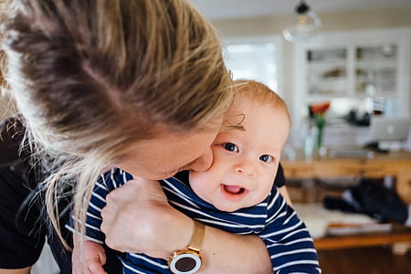 woman kissing cheek of child thumbnail