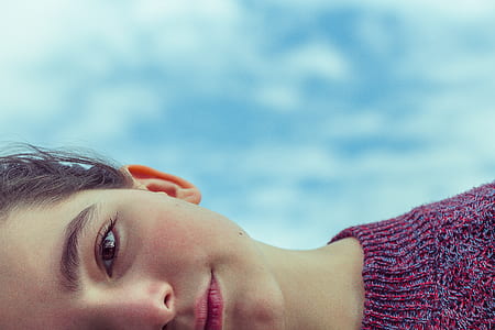 woman laying under blue sky thumbnail