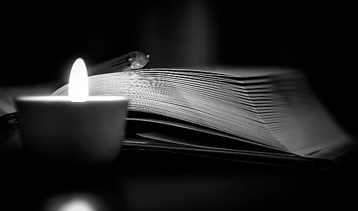 open book near candle thumbnail