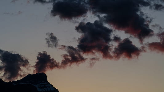 mountain under dark clouds during sunset thumbnail