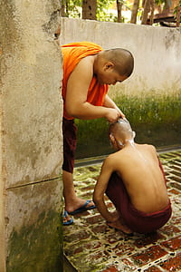 man shaving another man's head thumbnail