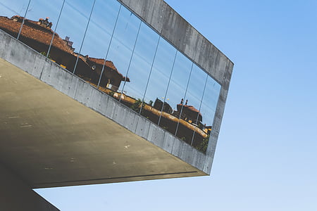 low-angle photo of building with mirror window at daytime thumbnail