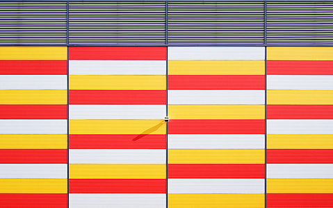 architectural photography of white, red, and yellow gate thumbnail