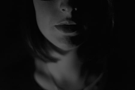 grayscale photo of woman with dim lights thumbnail