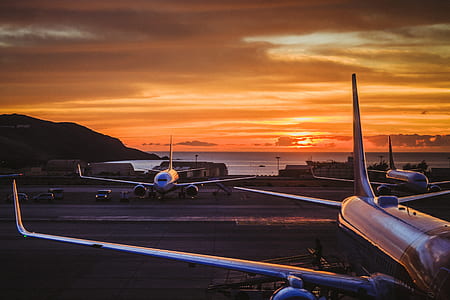 parked airliners during sunset thumbnail