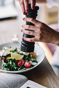 Woman eating breakfast and reading a book thumbnail