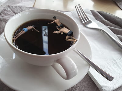 three boys diving in cup of coffee on table thumbnail