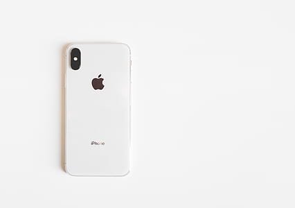 silver iPhone X on white surface thumbnail