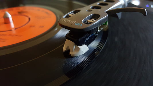 gray and black Stanton turntable playing black vinyl record thumbnail
